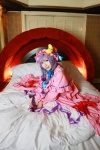 Rating: s Score: -1 Tags: 1girl asian bed blanket cosplay crescent dress female hat highres long_hair patchouli_knowledge photo pillow purple_hair solo tenshi_myu touhou